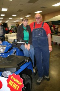 Harold Sullins of Licking purchased the winning ticket for the four-wheeler raffled at the cook off. He stands with his wife, Linda, by the ATV. 