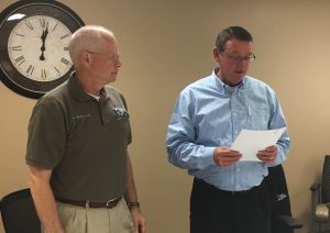 Dr. Jim Perry, OD, chair of the Texas County Memorial Hospital board of trustees, administers the oath of office to the newest TCMH board member, Jay Loveland.