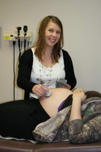 Tracey Arwood with a patient at the TCMH Medical Complex.