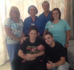 Baby Abel Hance was the first child born through “gentle” C-section at TCMH. He’s here with his mother, Jasmine Atkinson and River Hance (front). Back left to right are part of the obstetrics and surgery team at TCMH, Angela Watkins, obstetrics department director; Heather Lobough, CRNA; Dr. Christopher Baldwin, delivering physician, and Brittany Shepherd, obstetrics RN.